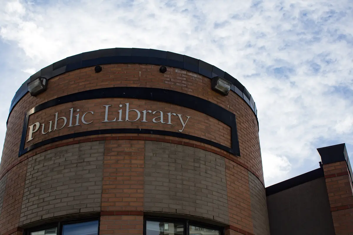 The curved brick corner of the library, with Public Library lettering across its upper wall