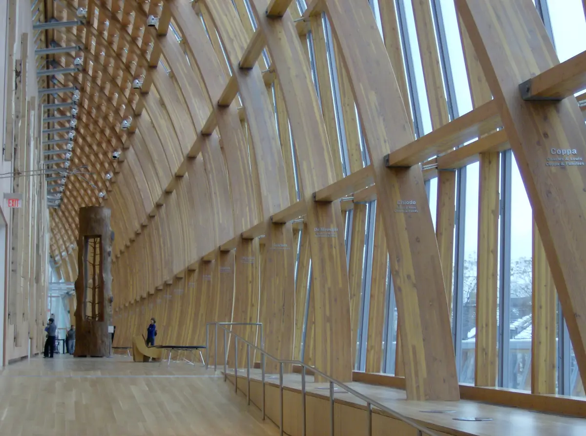 A long, timber-ribbed gallery with tall windows running along one side.