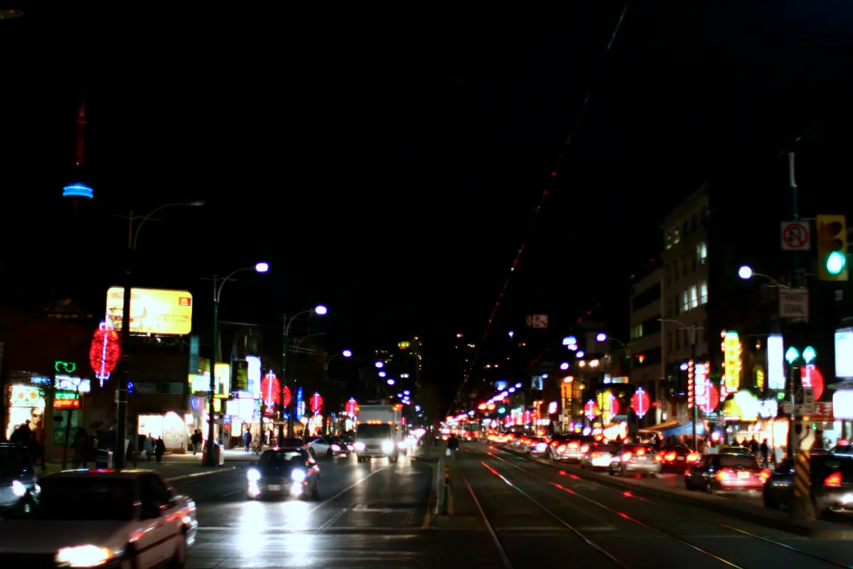 Spadina Avenue in Chinatown at night, lit with red lanterns and shop signs