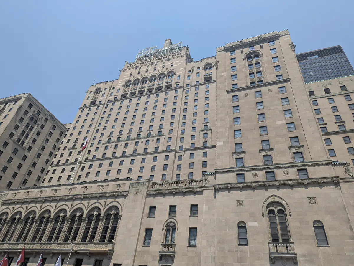 The Fairmont Royal York's stone facade rising into a pale sky