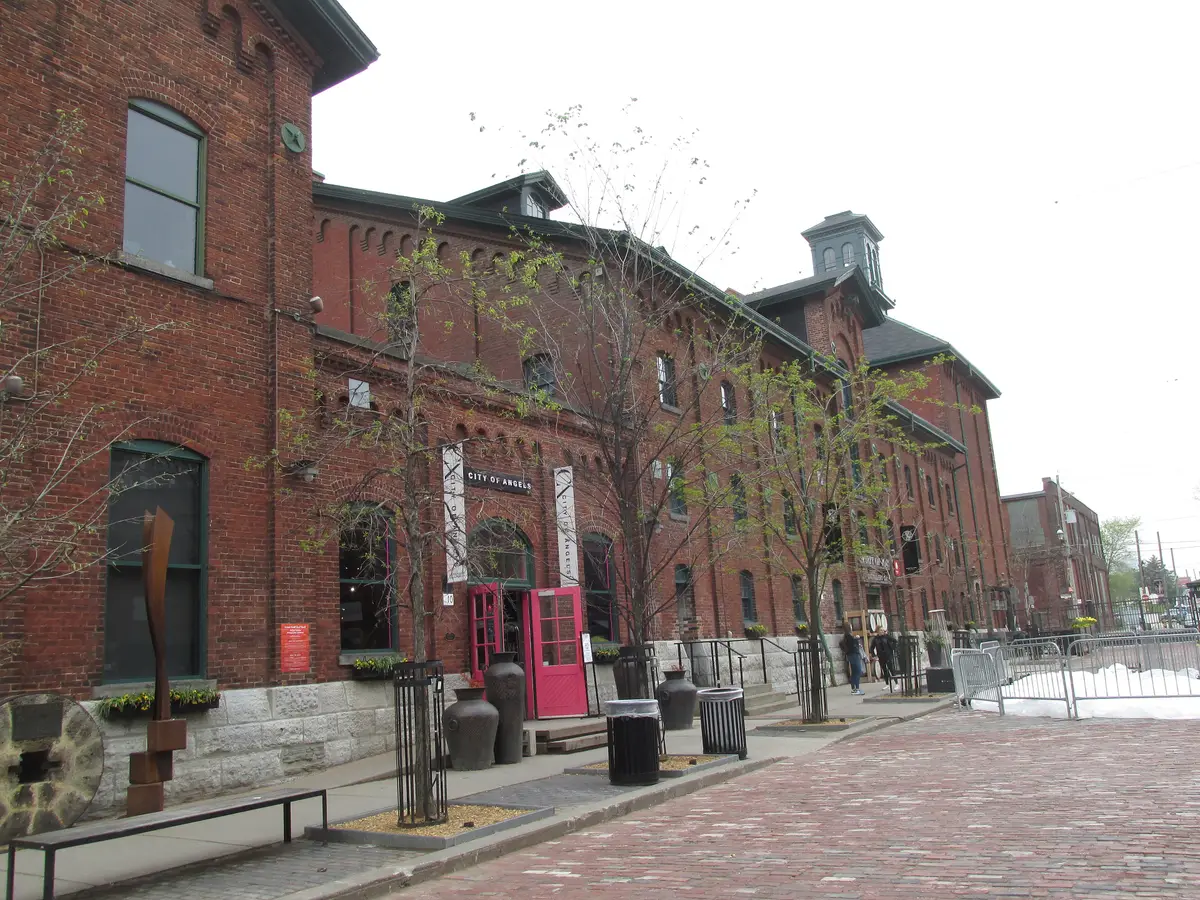 Red brick Victorian industrial buildings around a courtyard in the Distillery District
