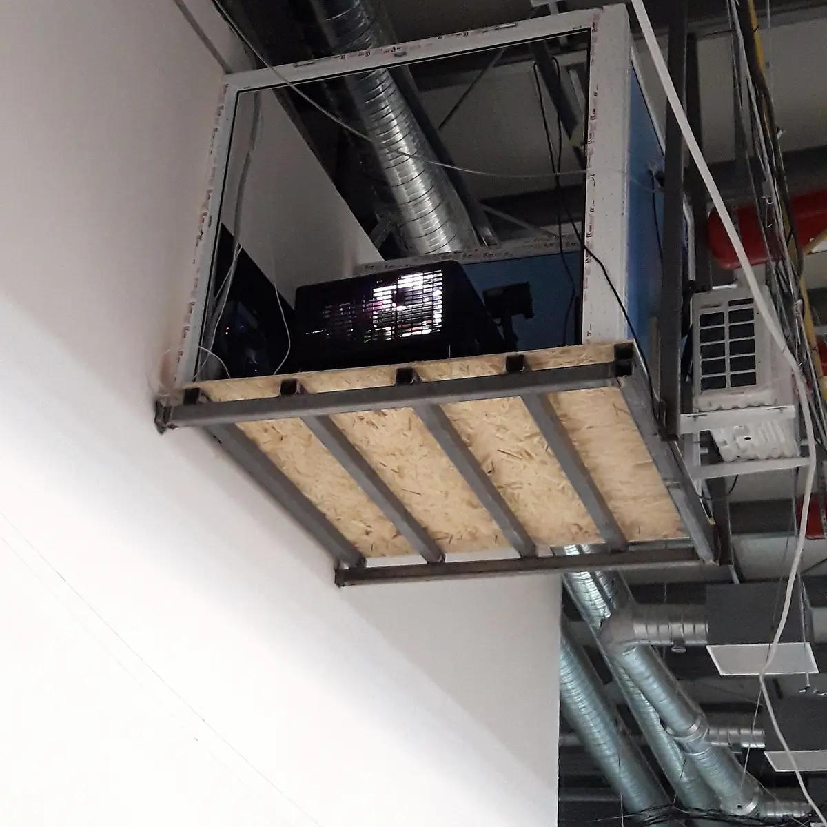 A digital cinema projector mounted on a wall