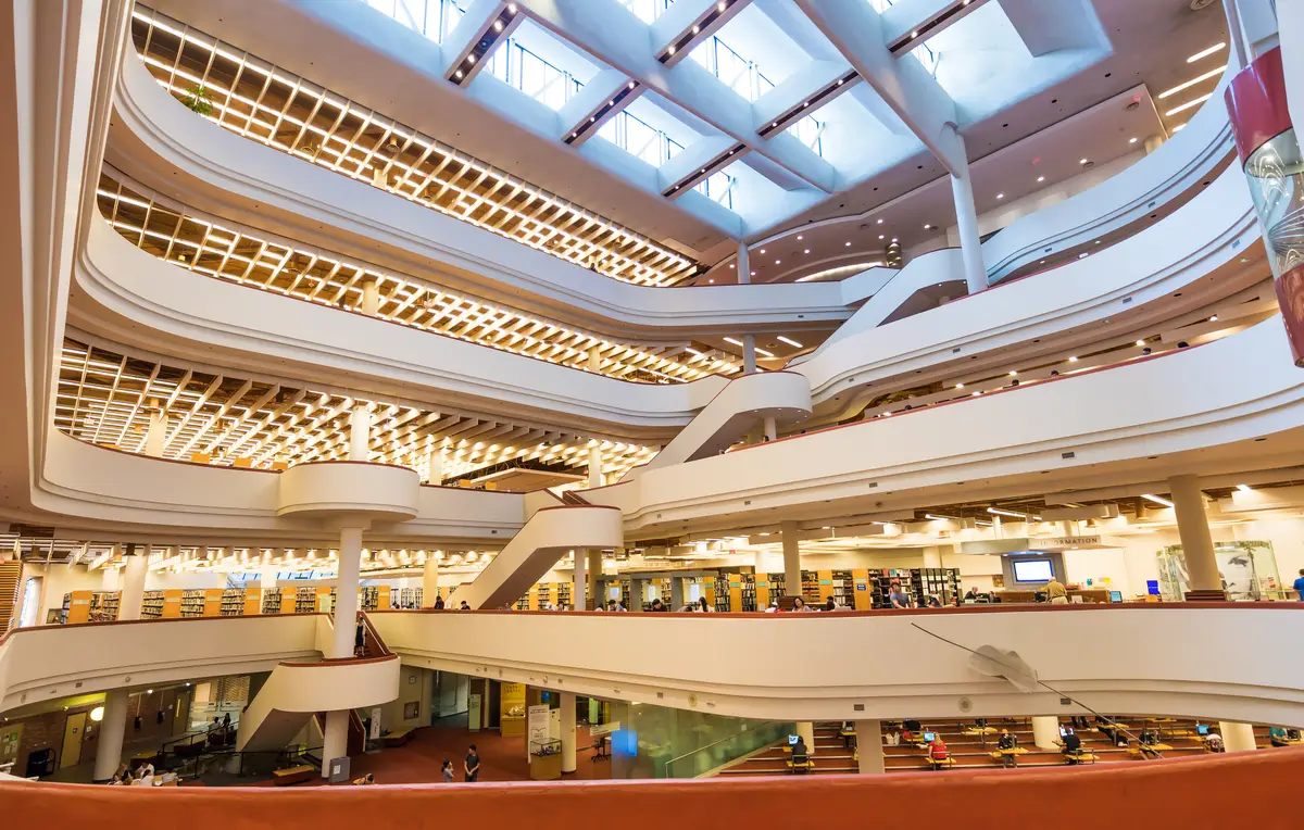 Curving balconies and a skylit ceiling rising above the open atrium of the Toronto Reference Library.
