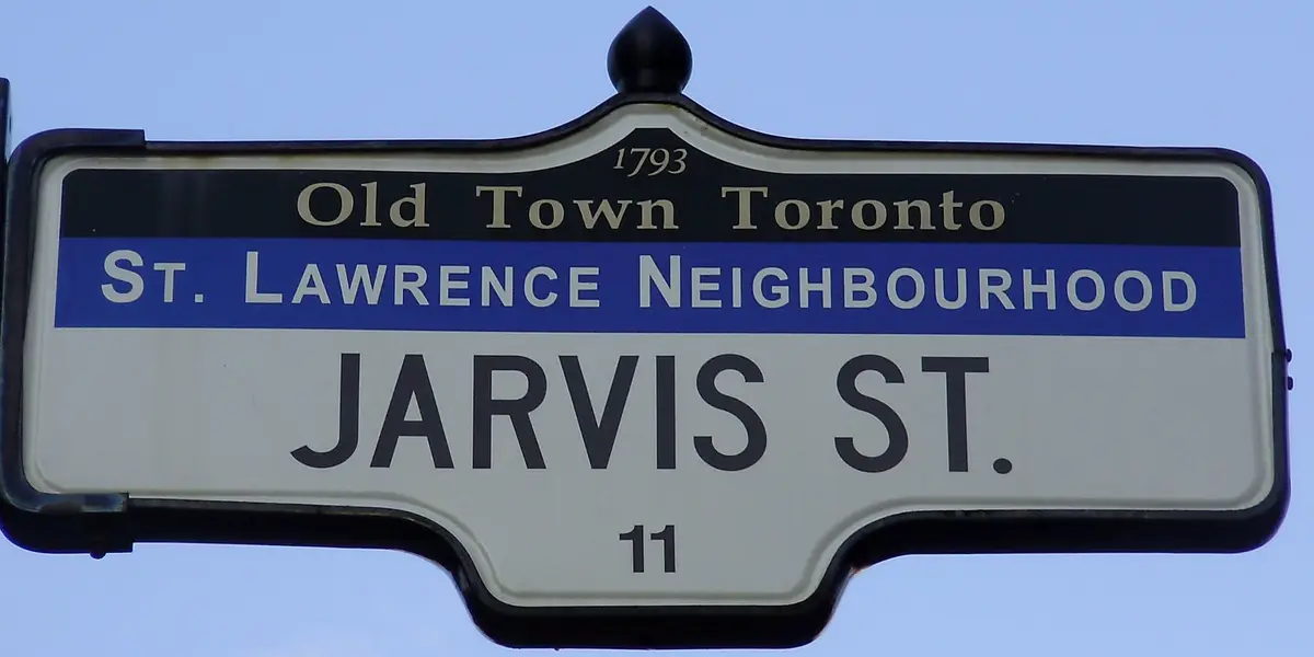A black, blue and white Jarvis Street sign reading Old Town Toronto and St. Lawrence Neighbourhood, with the year 1793 across the top