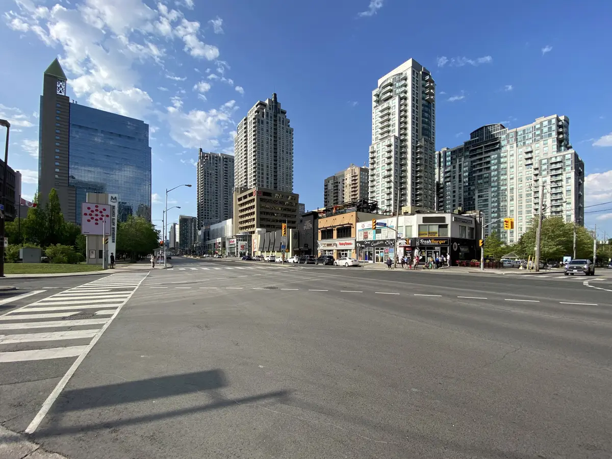 Yonge Street in North York Centre with high-rise towers under a blue sky