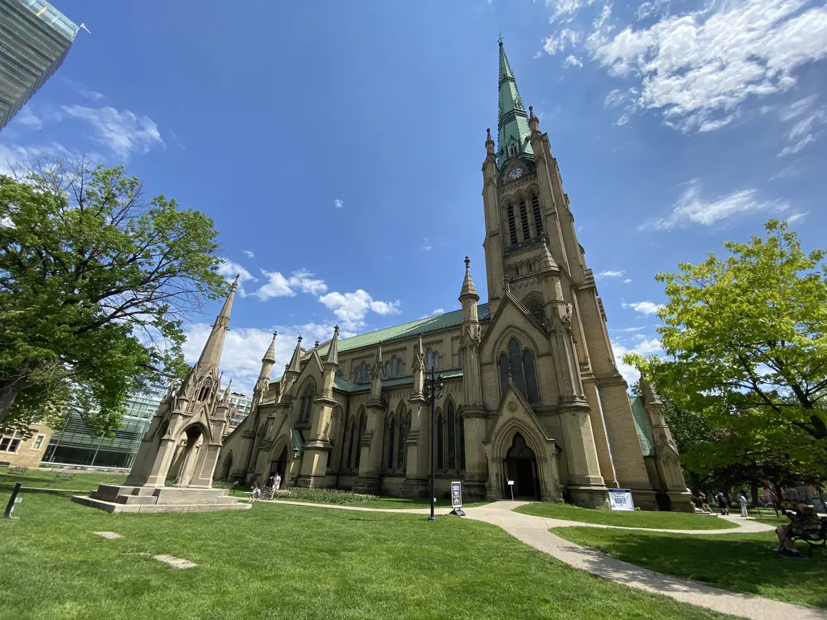 The Cathedral Church of St. James, its stone walls and green spire rising above a lawn and trees