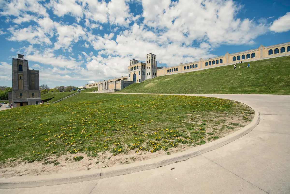 The R.C. Harris Water Treatment Plant's towered facade and long arched wall rising above a grassy slope