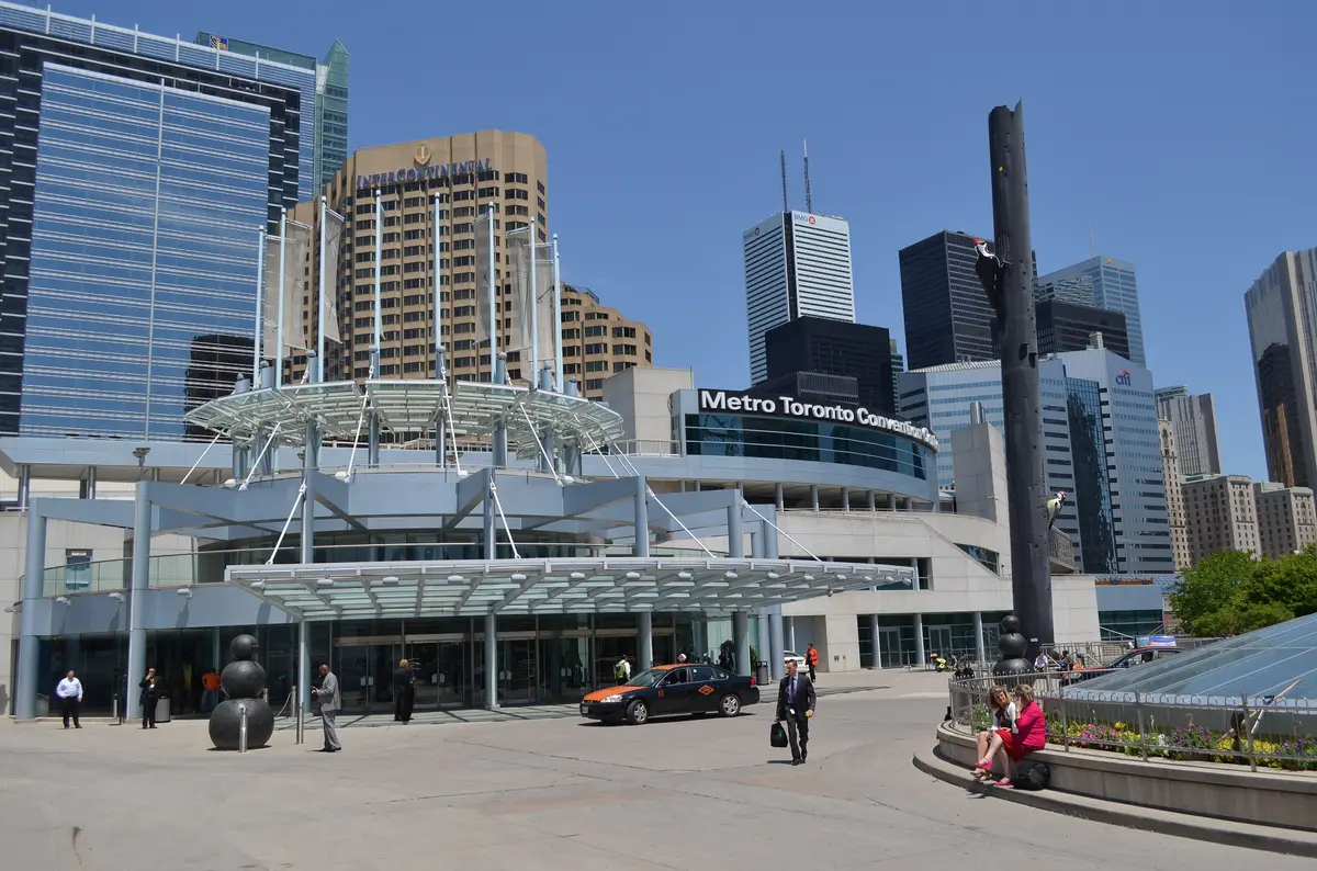 Entrance of the Metro Toronto Convention Centre under a glass canopy, with hotel and office towers behind