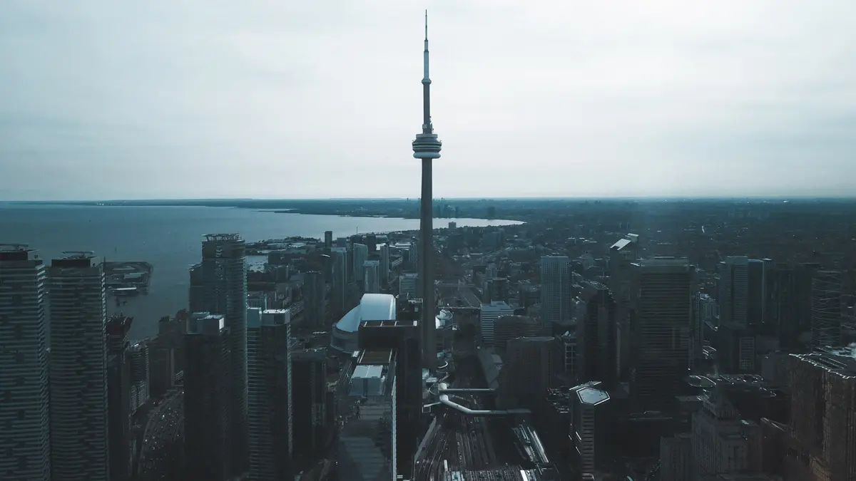 Aerial view of downtown Toronto towers and the CN Tower beside Lake Ontario under a grey sky