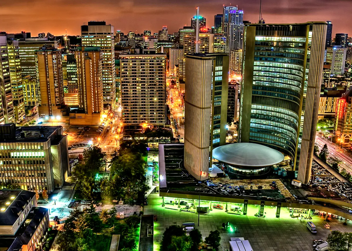 City Hall at night, with its two towers lit against the sky and the low, round Council Chamber between them