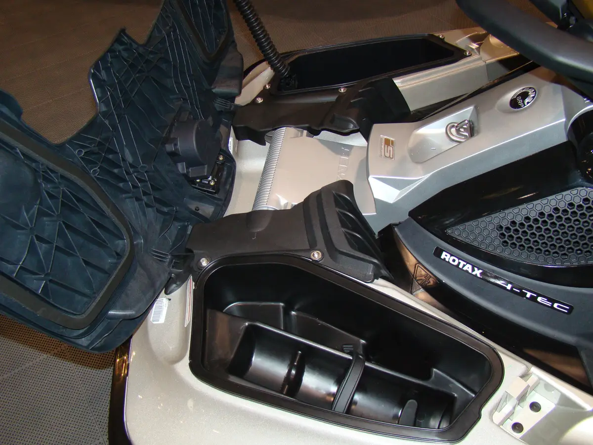 A close-up of a watercraft on display at the Toronto Boat Show in January 2009, with its storage compartments open and a Rotax 4-TEC engine cover visible