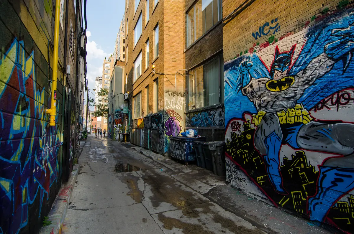 A Toronto laneway with walls covered in graffiti art and murals