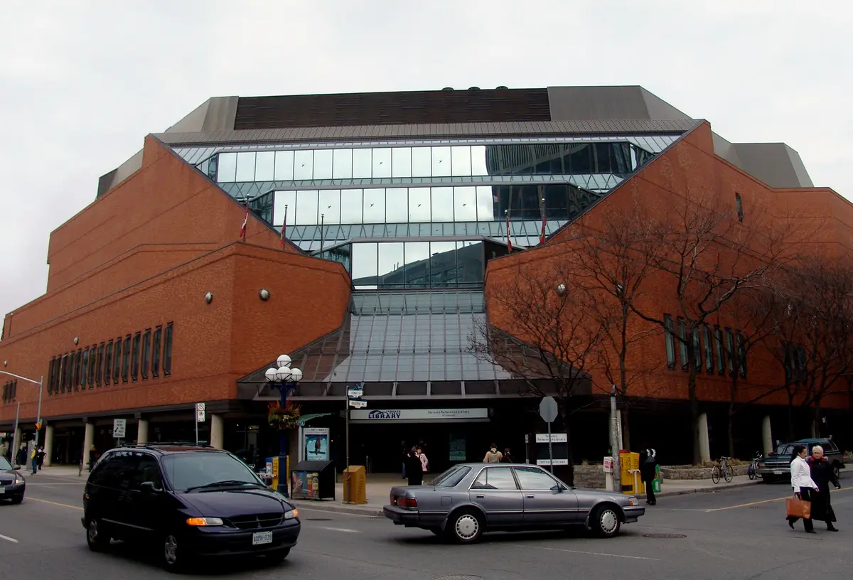 Brick and glass facade of the Toronto Reference Library with its sign at street level